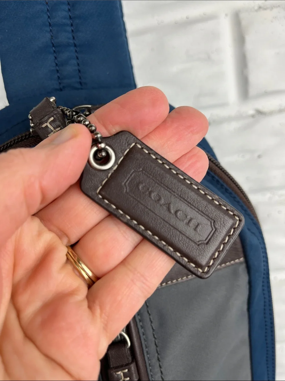 COACH Varick sling bag in navy blue / gray nylon with brown leather trim